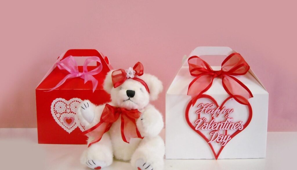Cuddly Teddy Bear Valentine's Day Wallpaper with Gift Boxes