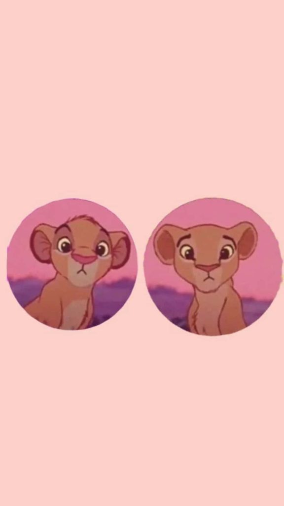 Adorable young Simba and Nala matching wallpaper on pastel pink Lion King background