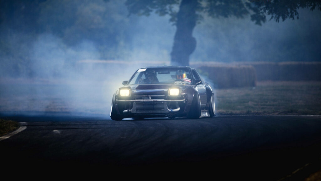 Adrenaline-Fueled Drifters: Unleashing Lightning on the Dark Asphalt Wallpaper