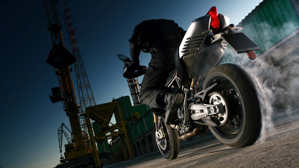 Adrenaline & Freedom: Motorbike Wallpaper on Industrial Backdrop