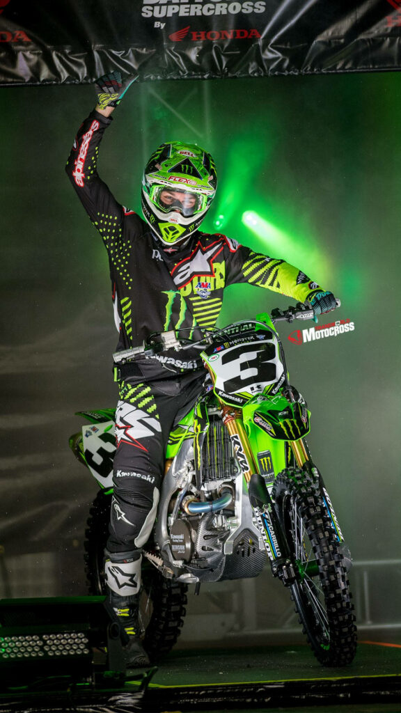 Adrenaline-Filled Rider on Monster Energy Kawasaki Dirt Bike Wallpaper