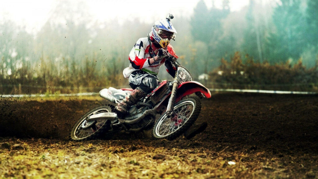 Thrilling Motocross Feats: A Courageous Dirt Biker Ready to Take Flight Wallpaper