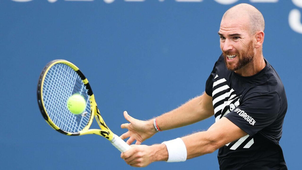 Adrian Mannarino hitting tennis ball on court intense focus dynamic sports action wallpaper