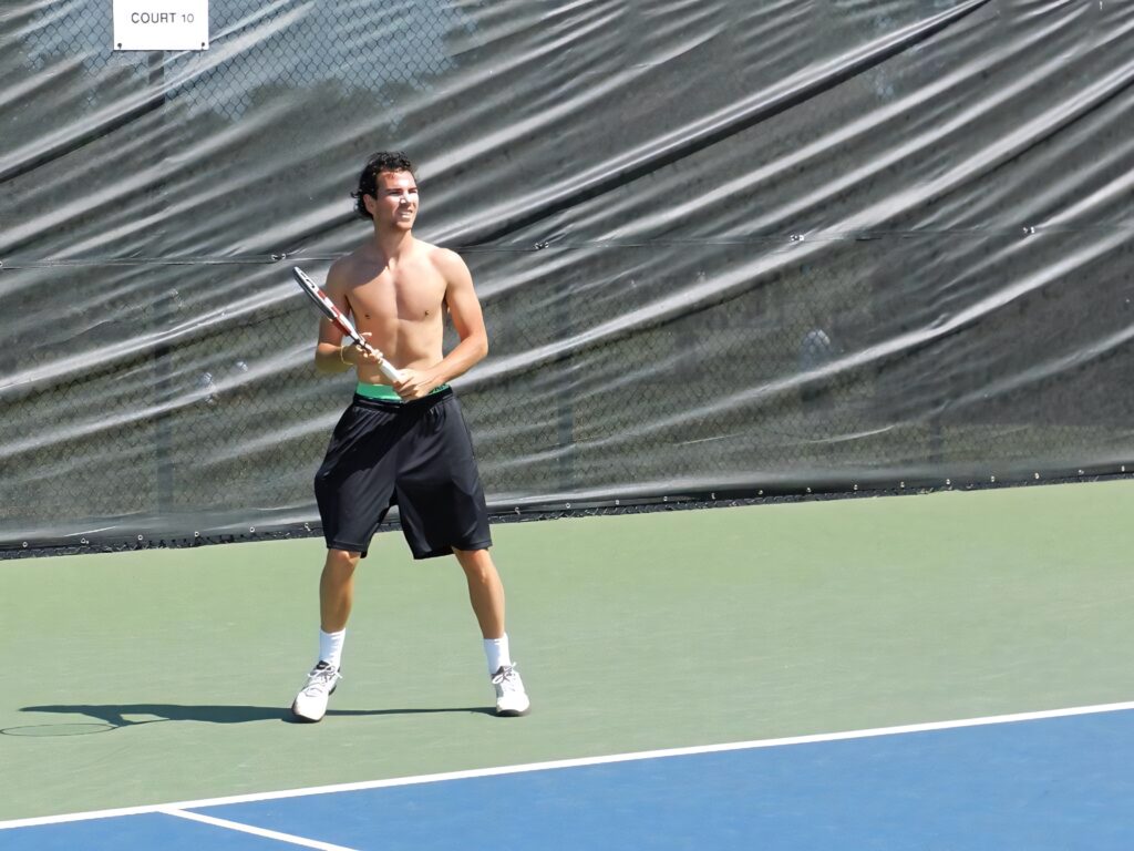 Adrian Mannarino intense tennis action on court showing focus and athletic skill wallpaper background