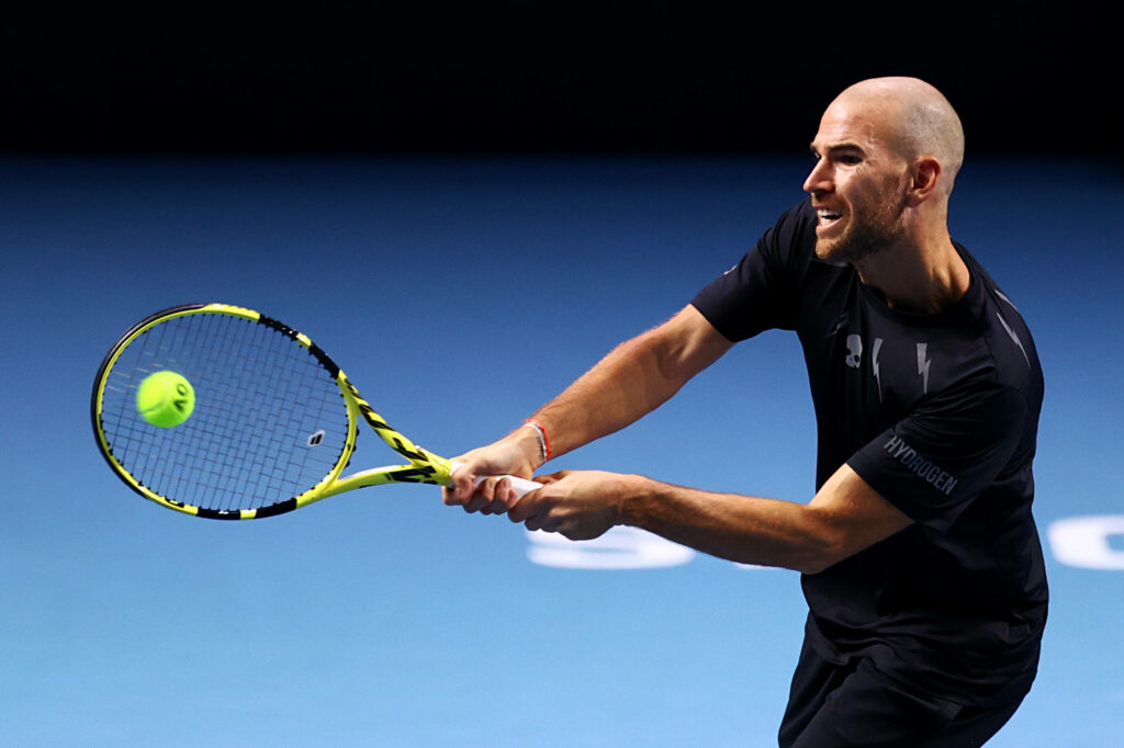 Adrian Mannarino intense tennis return shot showing skill and determination on court wallpaper