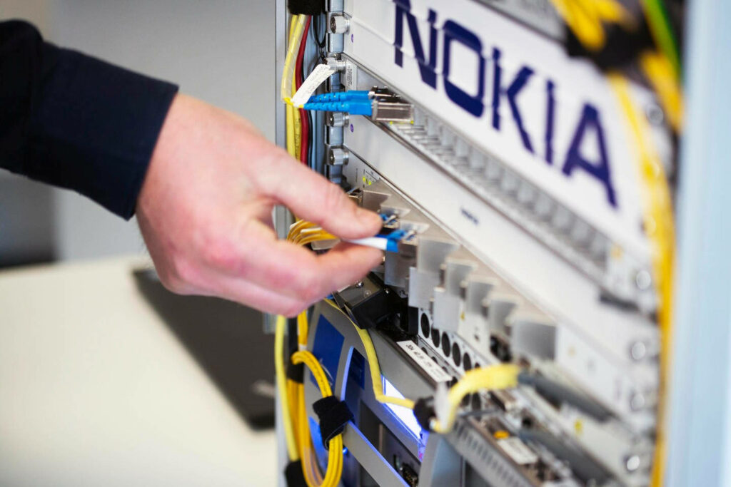 Technician Working on Nokia's Broadband Tech - Advanced Networking Wallpaper