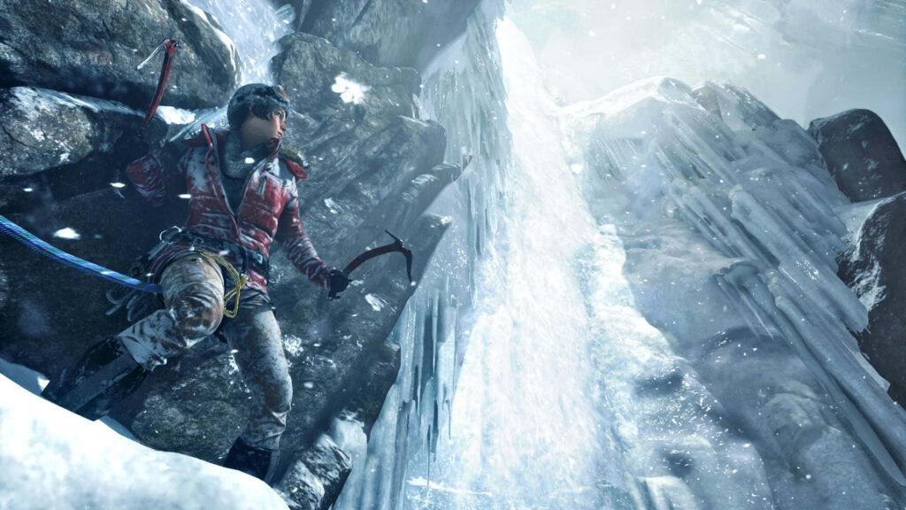 Dynamic Lara Croft climbing axe action pose from Rise of the Tomb Raider on icy cliff face Wallpaper