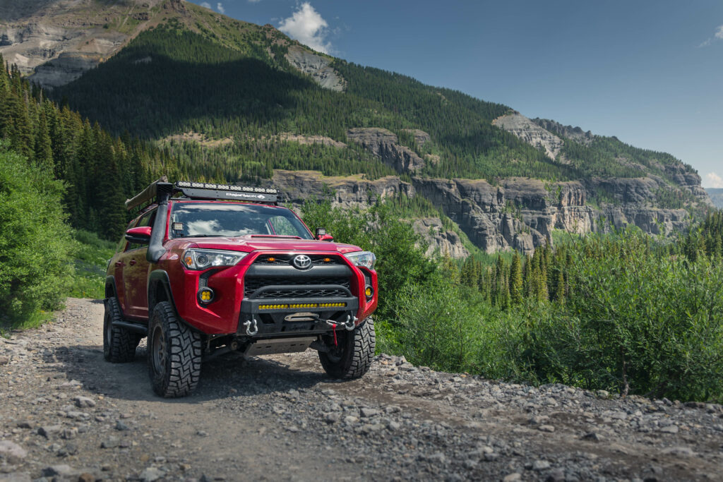Adventure Awaits: Red Toyota 4Runner in Rocky Terrain Wallpaper