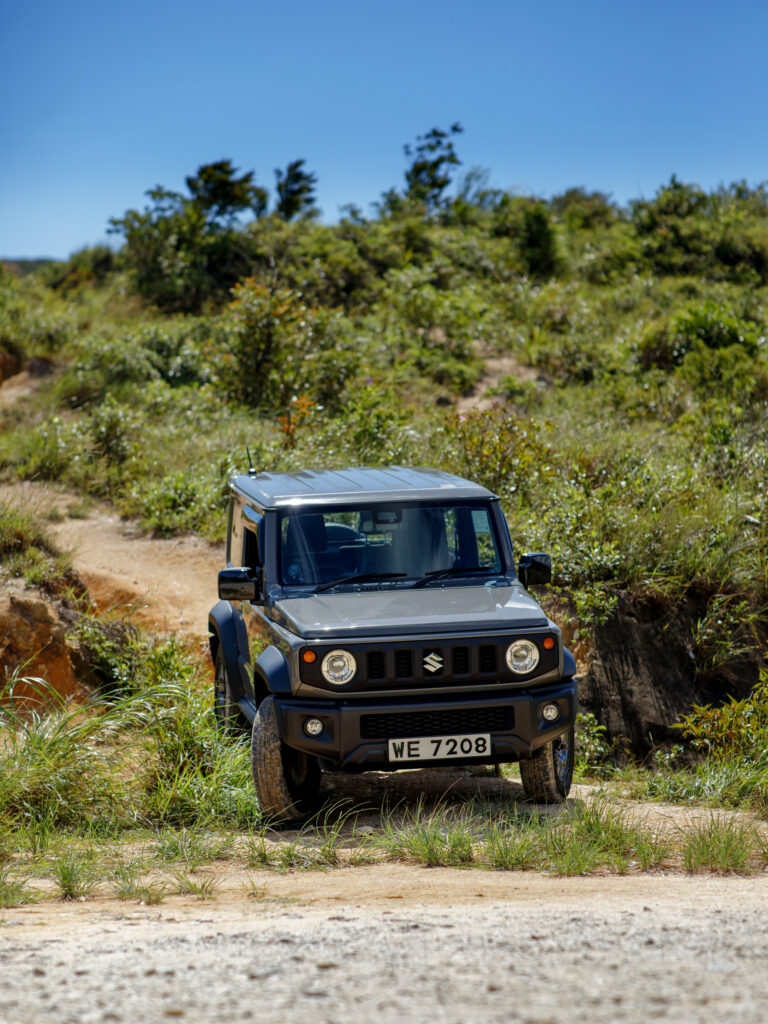 Sleek Suzuki SUV in Lush Off-Road Setting - Adventure Awaits! Wallpaper