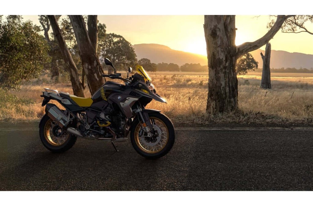 Sleek Adventure Sports Bike Wallpaper with Sunset and Mountain Views