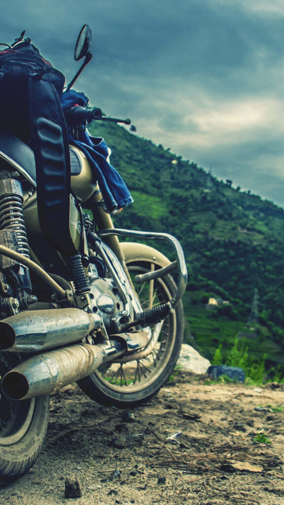 Adventure Awaits: Motorcycle Wallpaper on Rugged Cliff with Hills