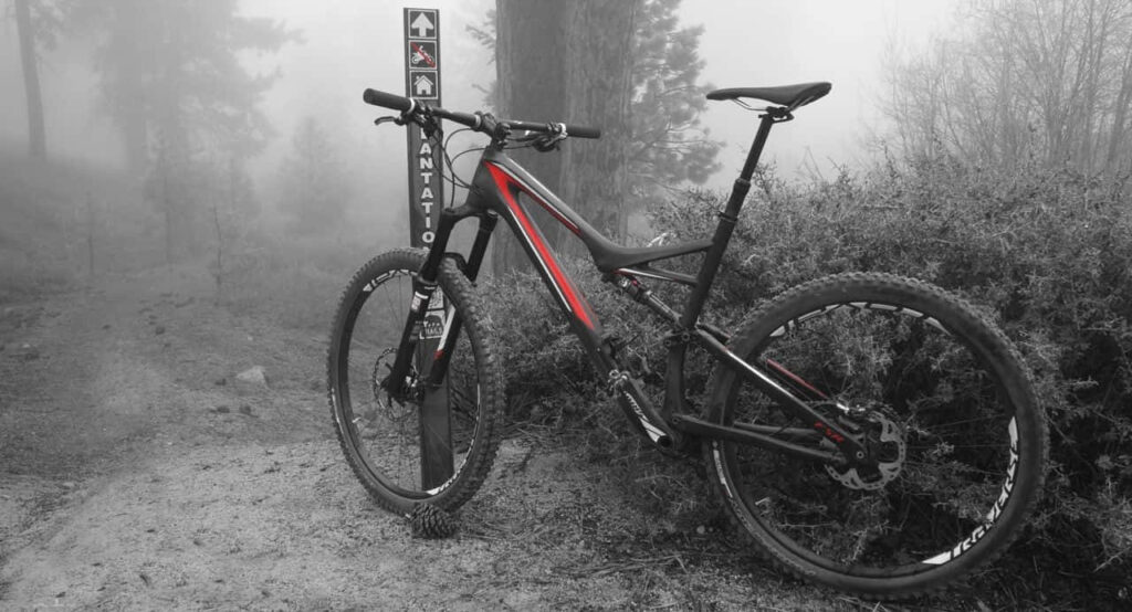 Serene Wallpaper: Specialized Mountain Bike on Misty Forest Trail