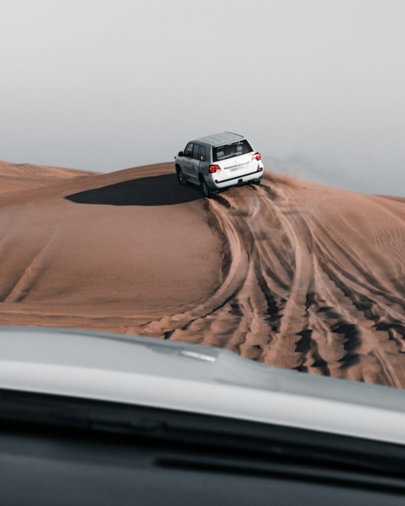 Dynamic Desert Adventure Wallpaper: Powerful Vehicle Tracks in Sand