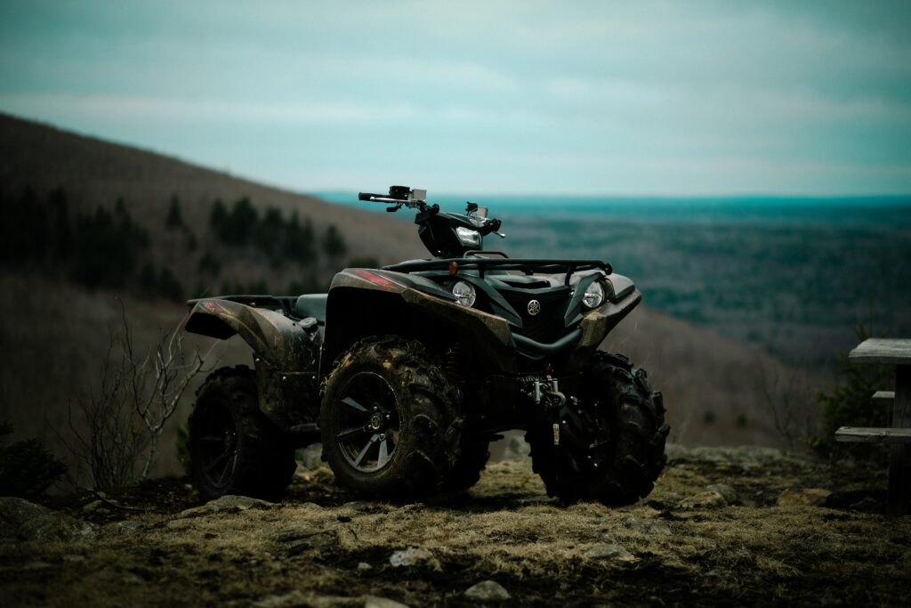 Adventure Awaits: ATV on Rugged Terrain with Stunning Landscape Wallpaper