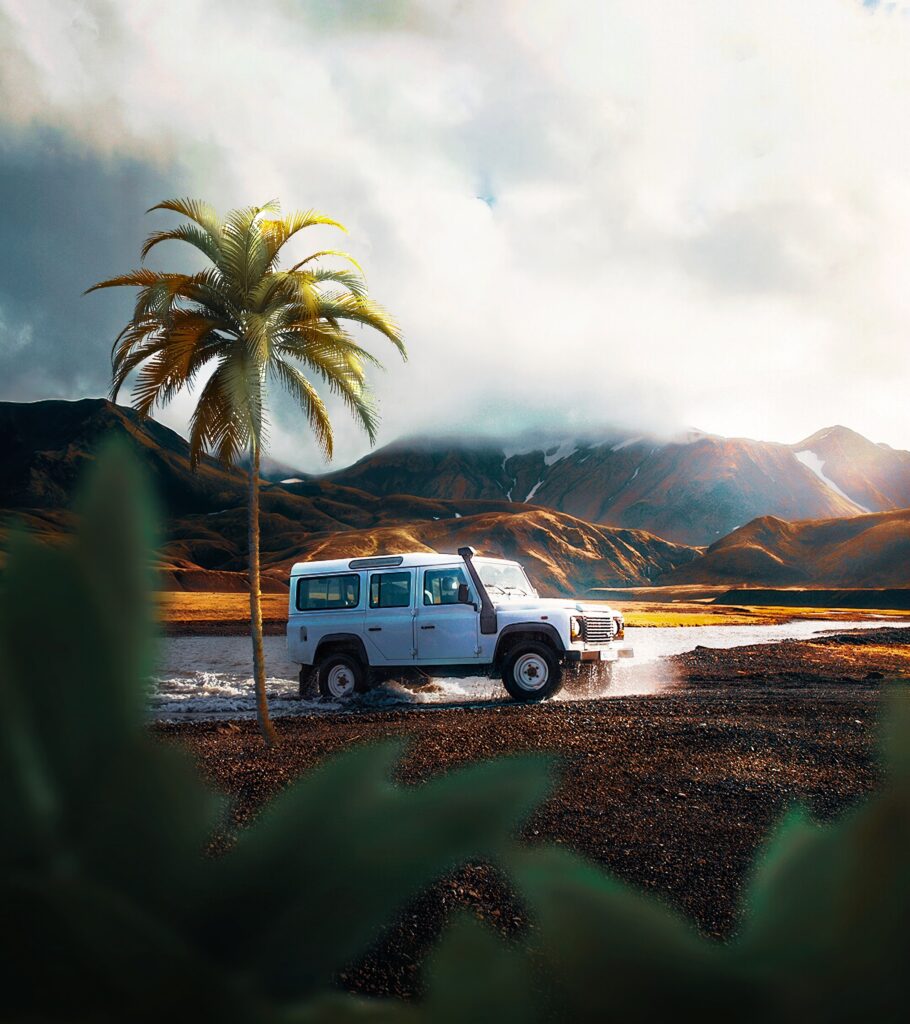 Rugged SUV Adventure in Scenic Landscape with Palm and Mountains Wallpaper