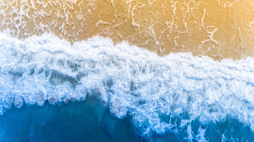 Aerial Beach Wallpaper: Ocean Waves & Sandy Shore Background