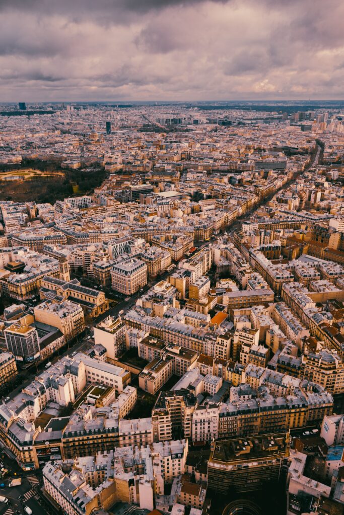 Aerial Cityscape Wallpaper: Stunning Skyline under Dramatic Clouds
