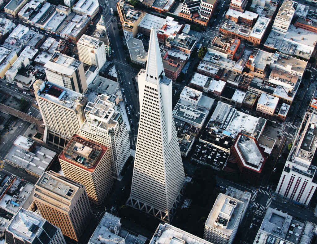 Aerial Cityscape Wallpaper: Triangular Tower & Diverse Architecture