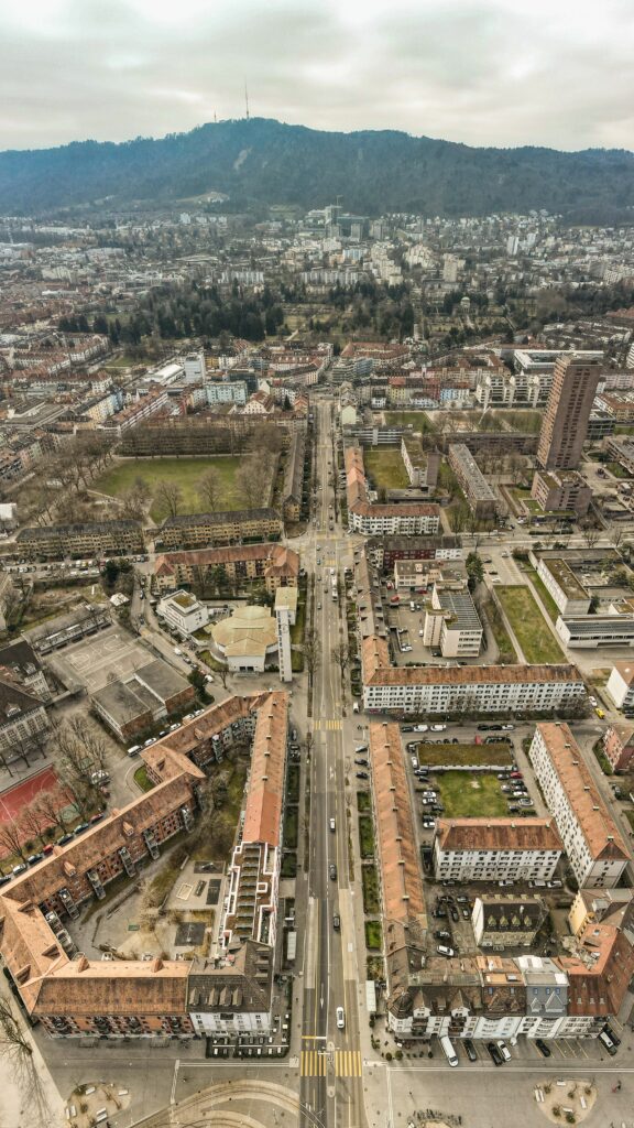 Aerial Cityscape Wallpaper: Urban Layout with Hillside Contrast