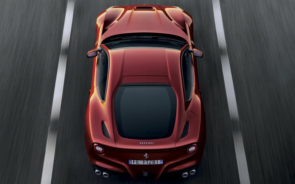 Stunning Aerial View of Ferrari F12 in Vibrant Red on the Road Wallpaper