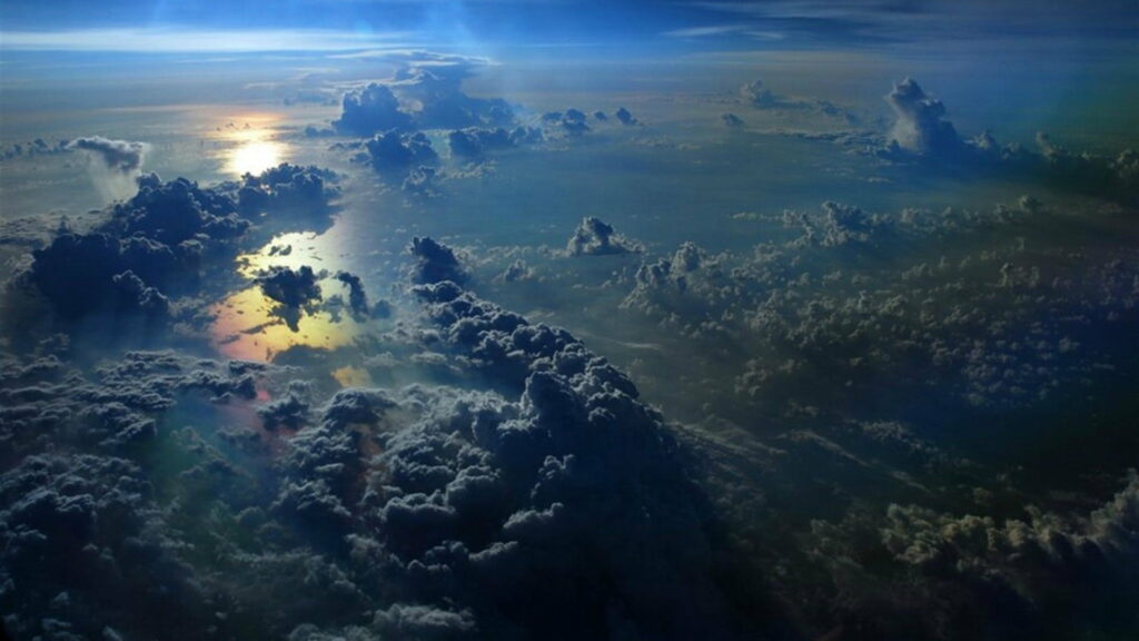 Breathtaking Sunset Aerial View of Sea with Dramatic Clouds Wallpaper