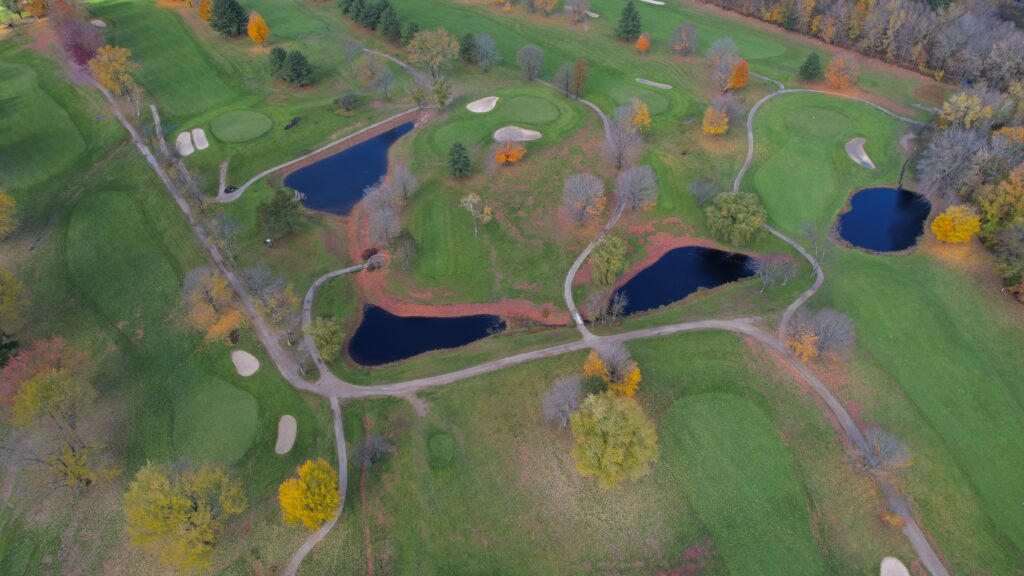 Aerial view of autumn park with winding paths sparkling lakes and colorful trees serene landscape Wallpaper