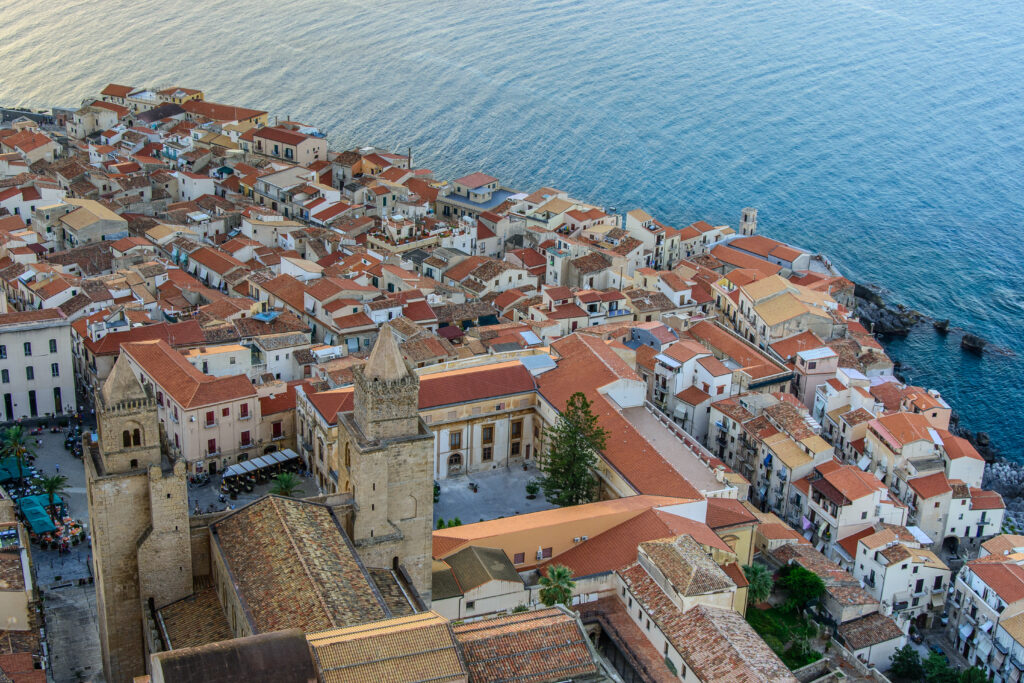Stunning Coastal City Aerial Wallpaper: Charming Houses & Blue Sea