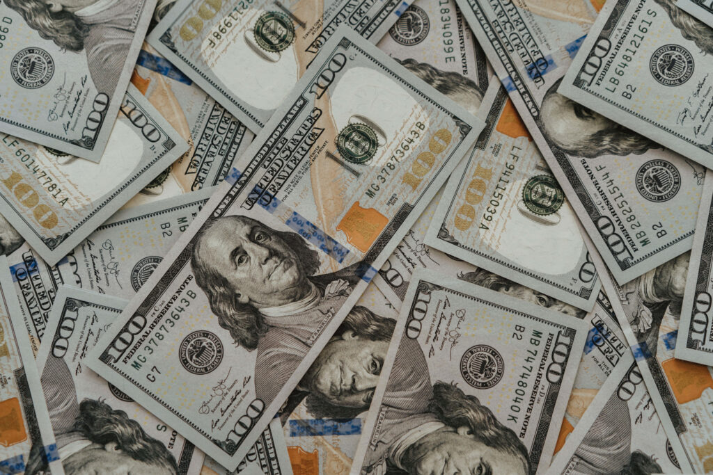 Countless Wealth: A Bird's Eye View of Abundant Cash Pile in Hundred Dollar Bills Wallpaper