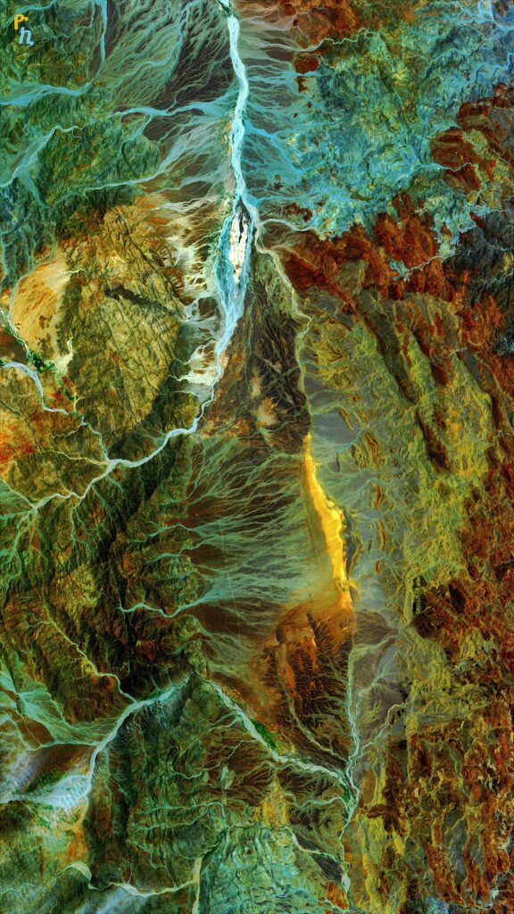 Aerial view of rugged mountains winding rivers and rocky terrain with vivid blue green waters wallpaper