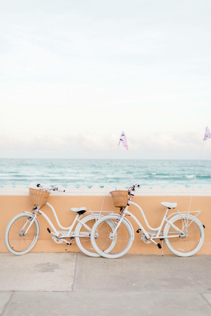 Aesthetic Beach: A Captivating Capture of White Bicycles and a Wall Wallpaper