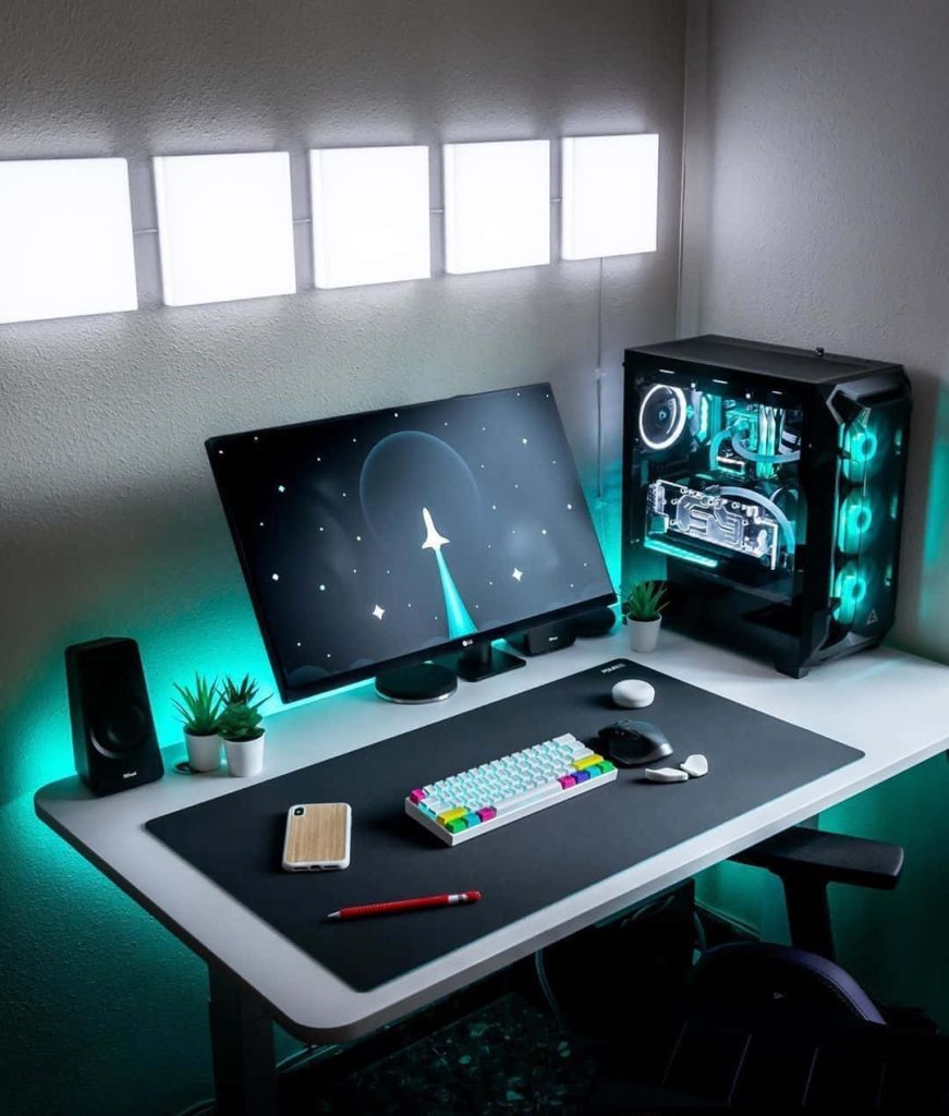 Gaming setup wallpaper with sleek PC mechanical keyboard teal LED rocket ship monitor