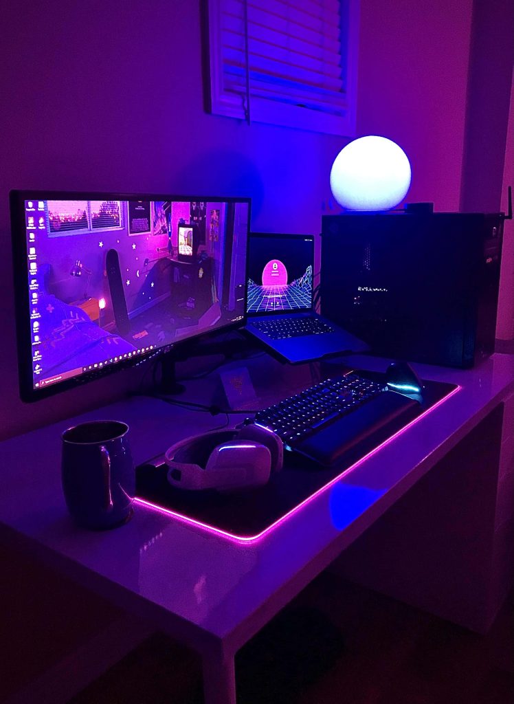 Aesthetic neon purple blue gaming setup with PC laptop mechanical keyboard and headphones wallpaper