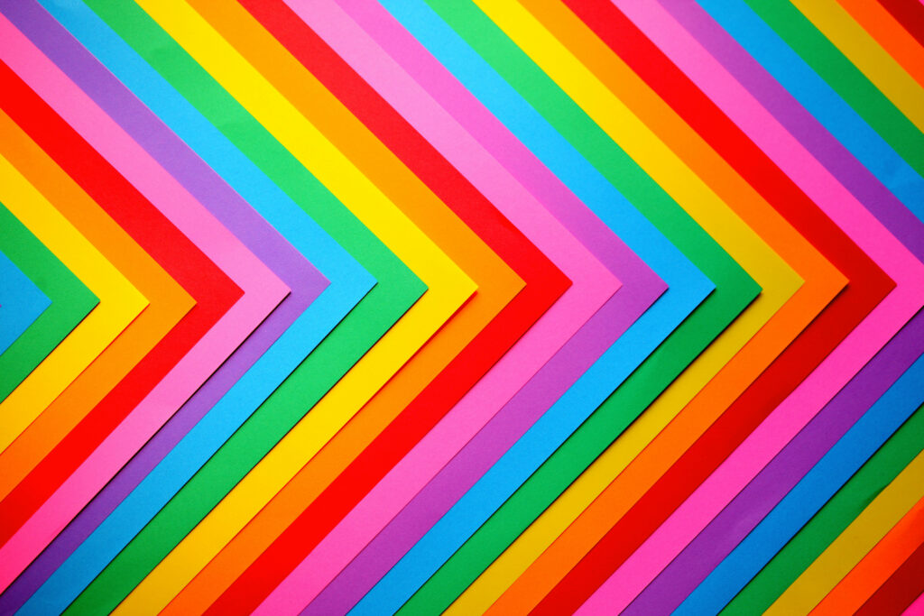 Vibrant Chevron Aesthetic: A Captivating Arrangement of Colorful Papers Embellishing the Background Wallpaper