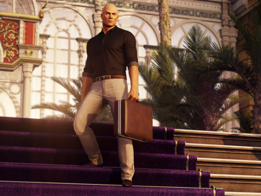 Agent 47 in black shirt beige trousers with briefcase descends grand staircase in luxury hotel Wallpaper