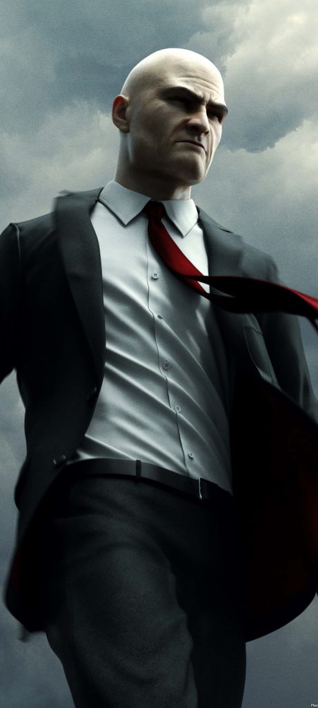 Agent 47 in black suit red tie under dark sky intense Hitman digital art wallpaper background
