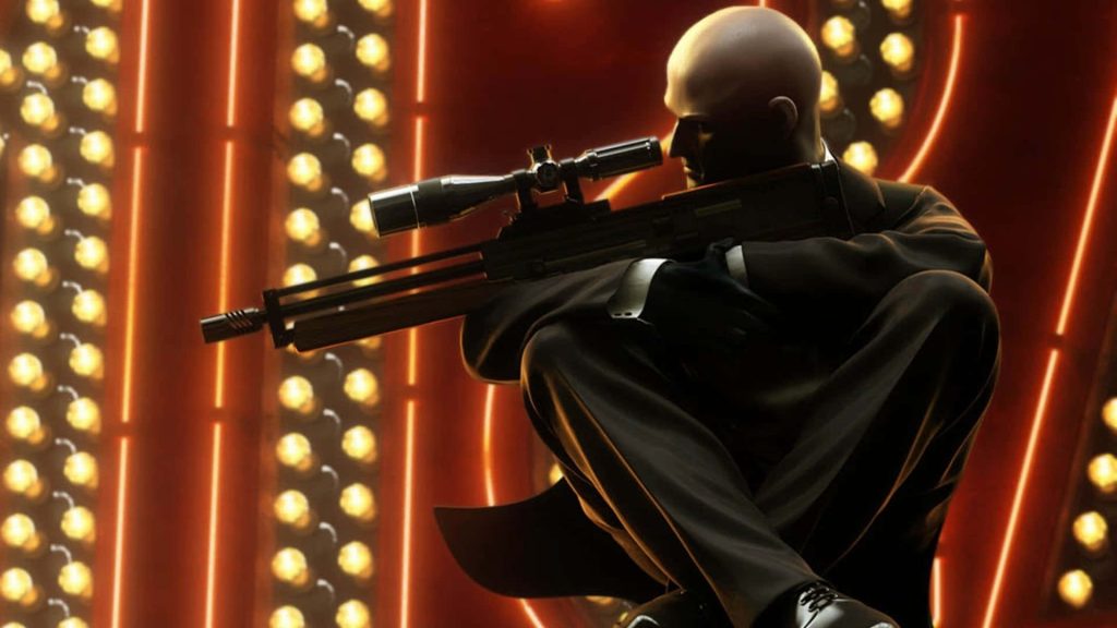 Agent 47 in suit holding sniper rifle against glowing circular lights Hitman 3 wallpaper background