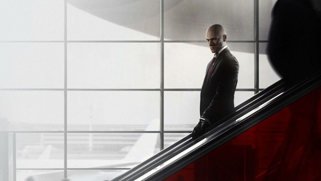 Agent 47's Stealthy Descent: Hitman Wallpaper Showcasing a Furtive Staircase Maneuver Amidst Expansive Airport Windows