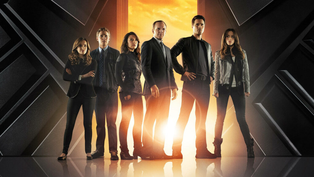 Agents of S.H.I.E.L.D. main characters united in dramatic pose with glowing sunset and metallic background Wallpaper