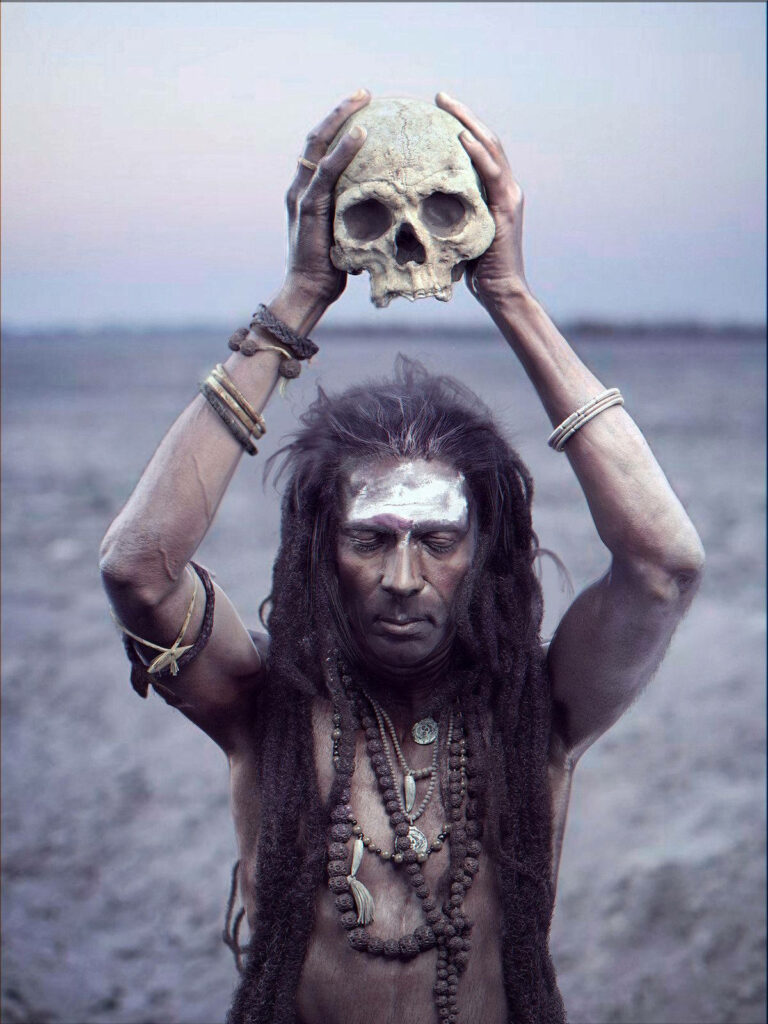 Aghori ascetic holding ritual skull with beads sacred symbols barren spiritual landscape wallpaper