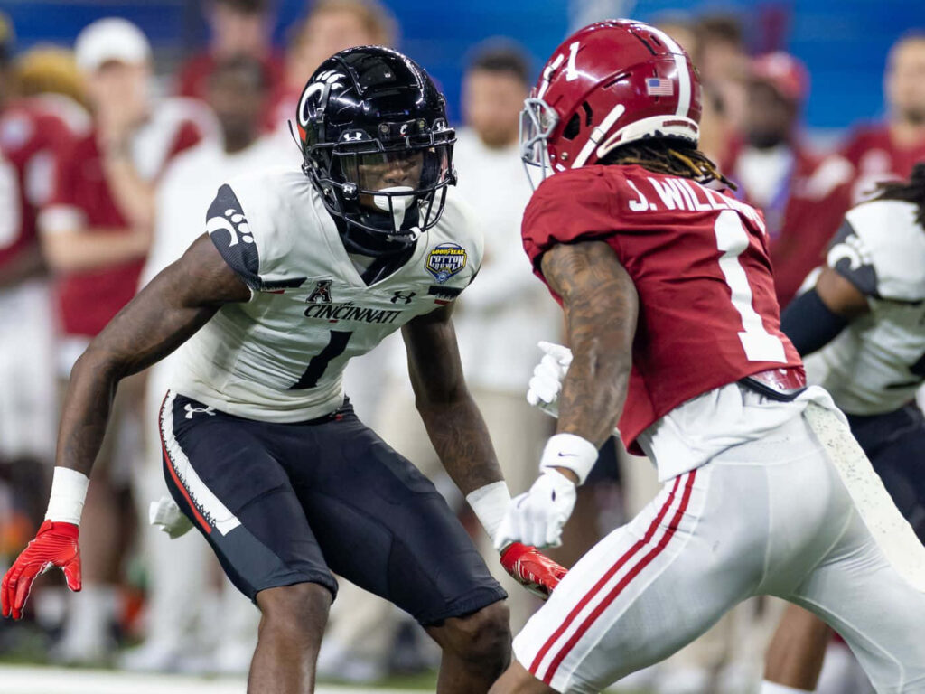 Ahmad Sauce Gardner Cincinnati defender challenges Alabama player in intense football game action Wallpaper