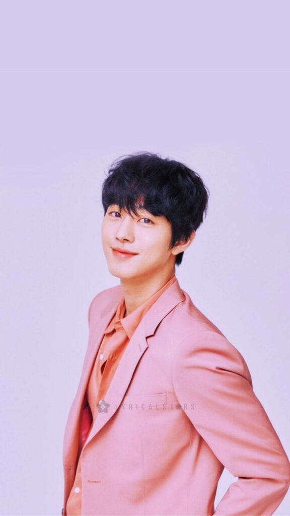 Ahn Hyo-seop in pastel pink suit on soft pink background cheerful stylish wallpaper background