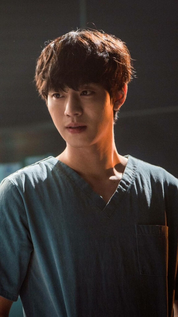 Ahn Hyo-seop in soft light with thoughtful expression captivating wallpaper background