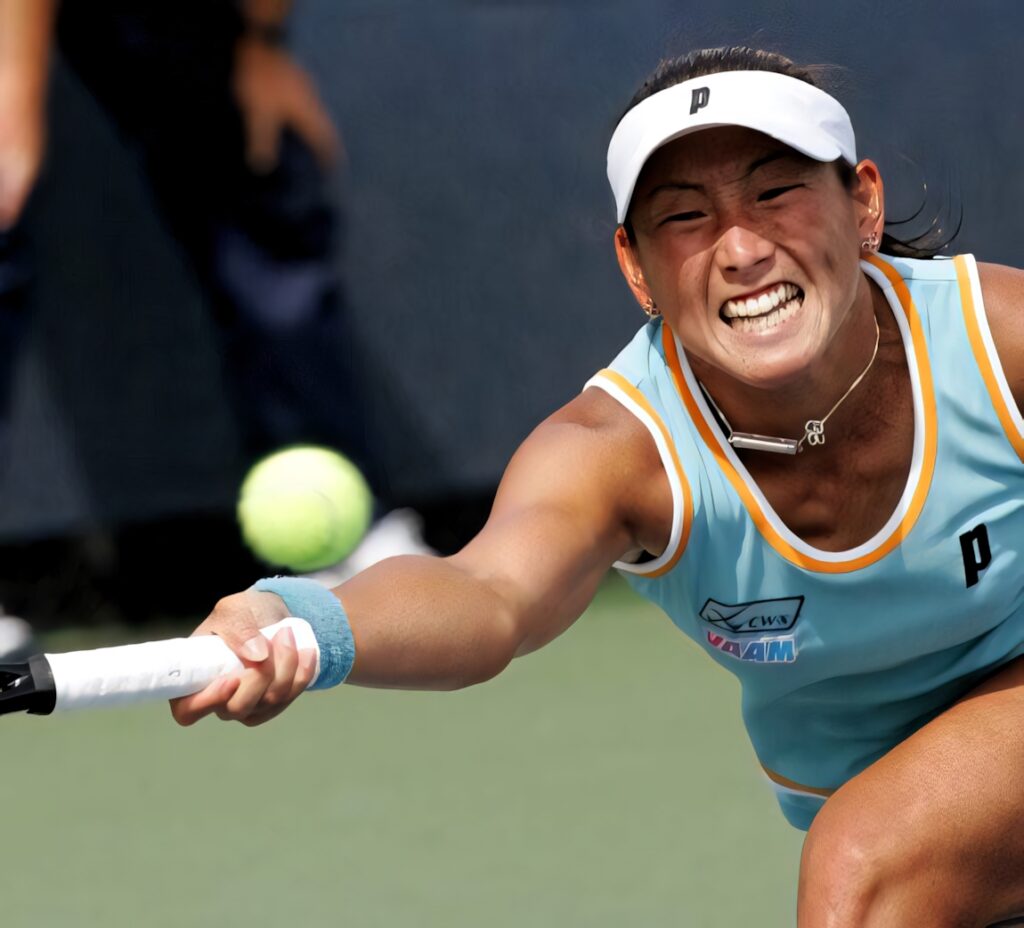 Ai Sugiyama intensely chasing fast tennis ball fully stretched on court action wallpaper background