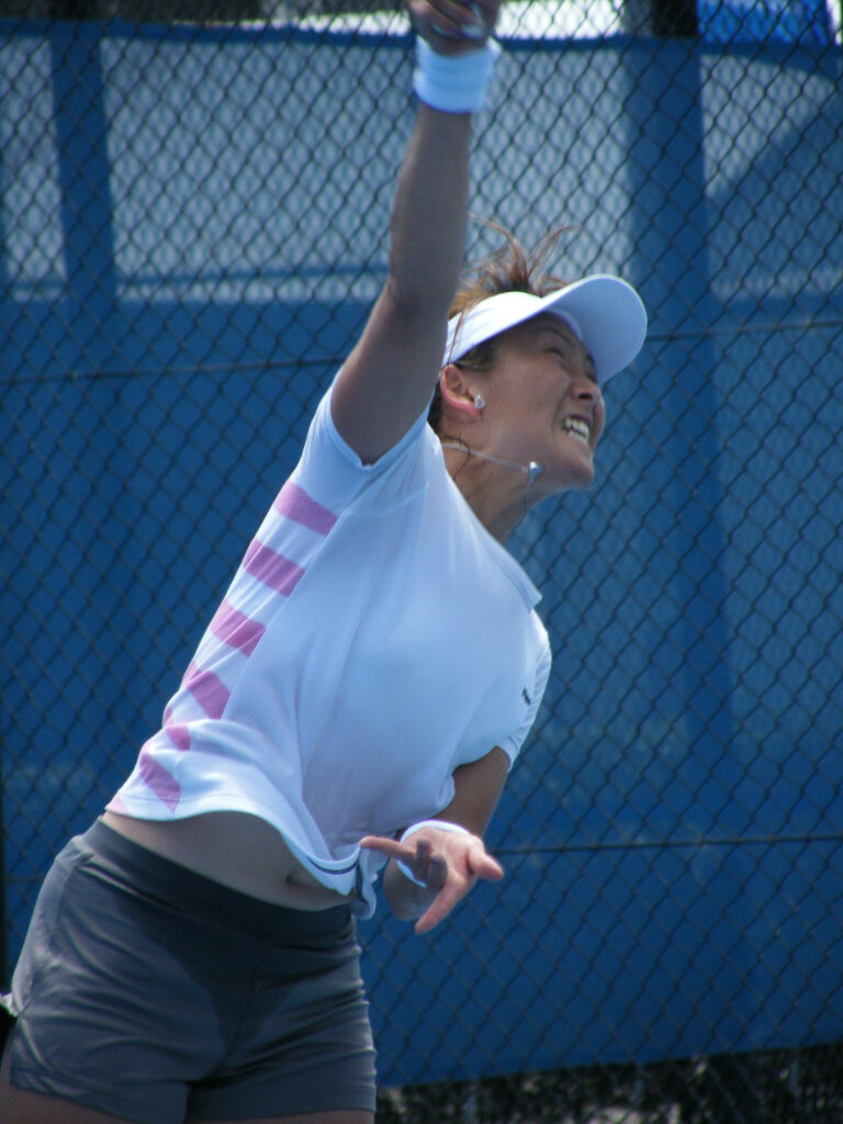 Ai Sugiyama powerful tennis shot in match showcasing athleticism and focused gameplay Wallpaper