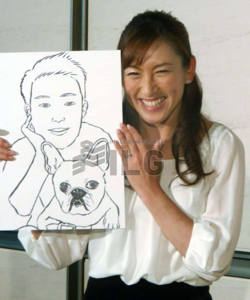 Ai Sugiyama smiling warmly holding a sketch drawing vibrant friendly wallpaper background