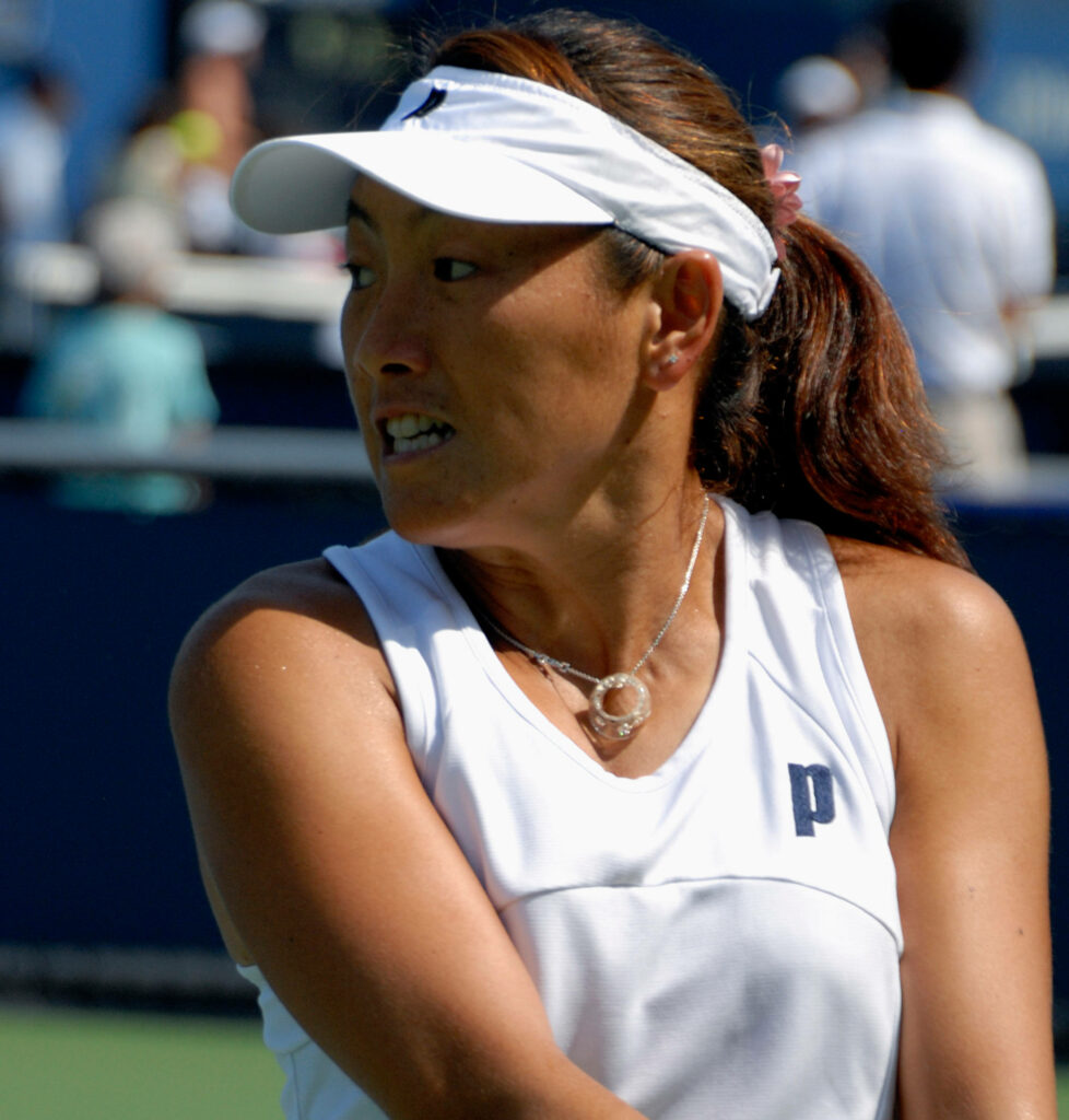 Ai Sugiyama competing fiercely in tennis match showing focus determination and competitive spirit Wallpaper