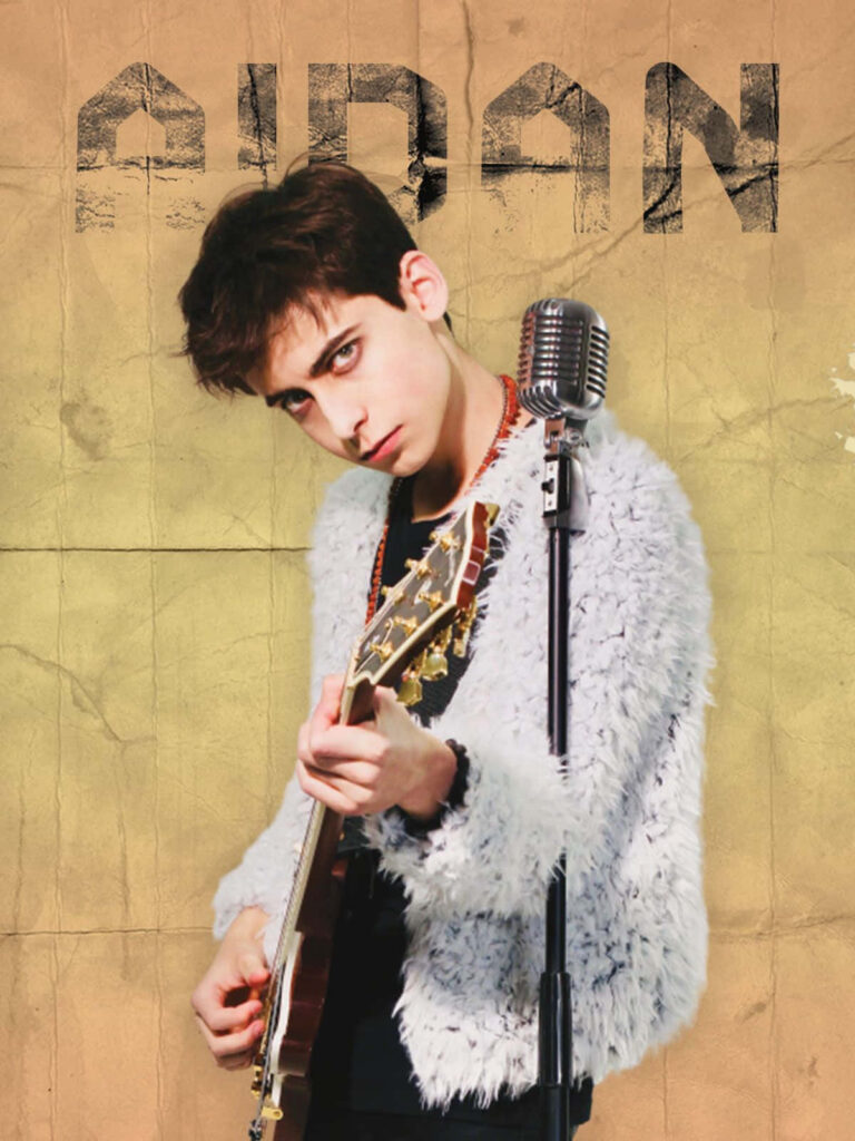 Aidan Gallagher performing energetically with guitar by vintage microphone and name backdrop Wallpaper