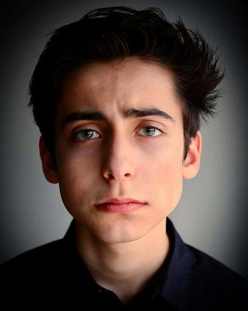 Aidan Gallagher intense gaze youthful determination Hollywood rising star wallpaper background