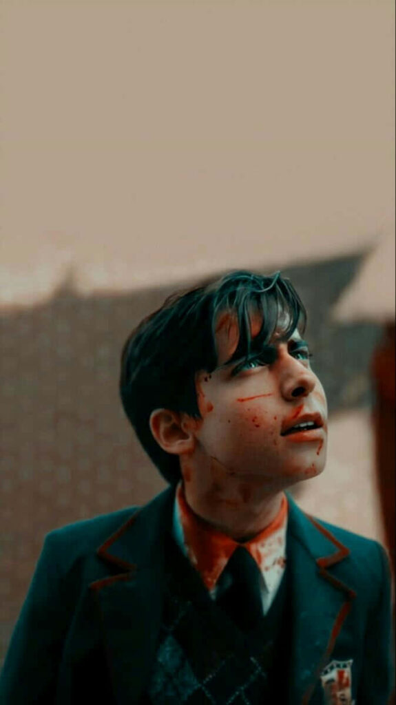 Aidan Gallagher in bloody school uniform profile with blurred cityscape wallpaper background