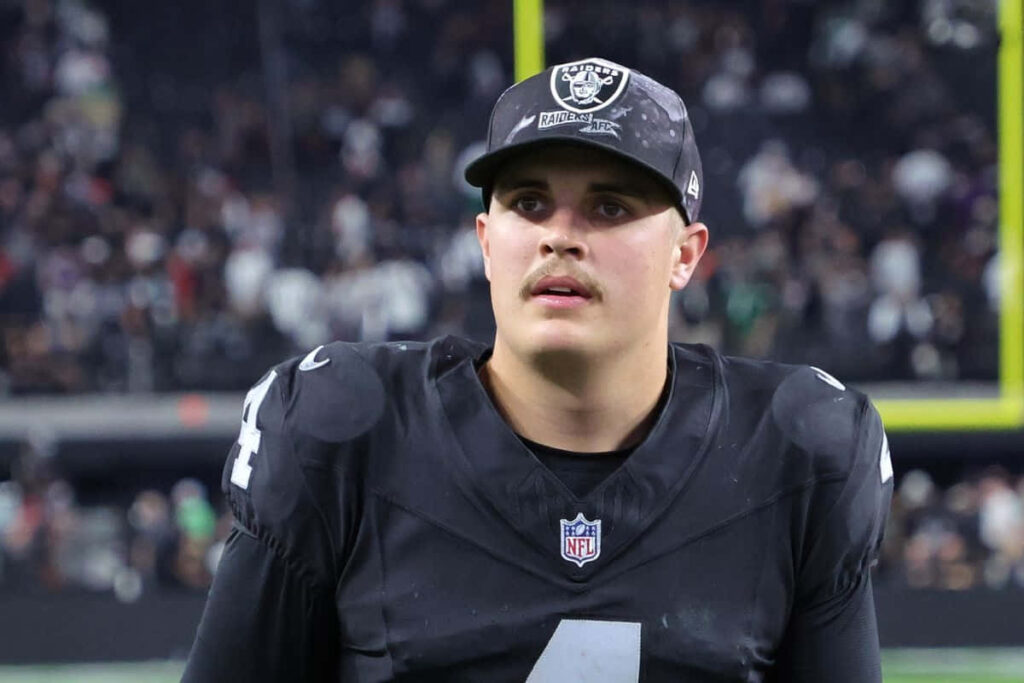 Aidan O'Connell focused in black football uniform NFL quarterback intense game action wallpaper